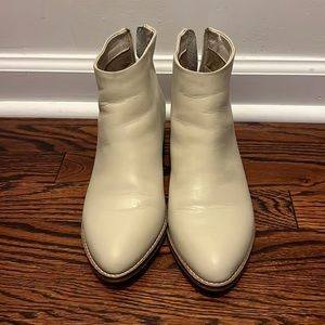 Cream low heeled booties.